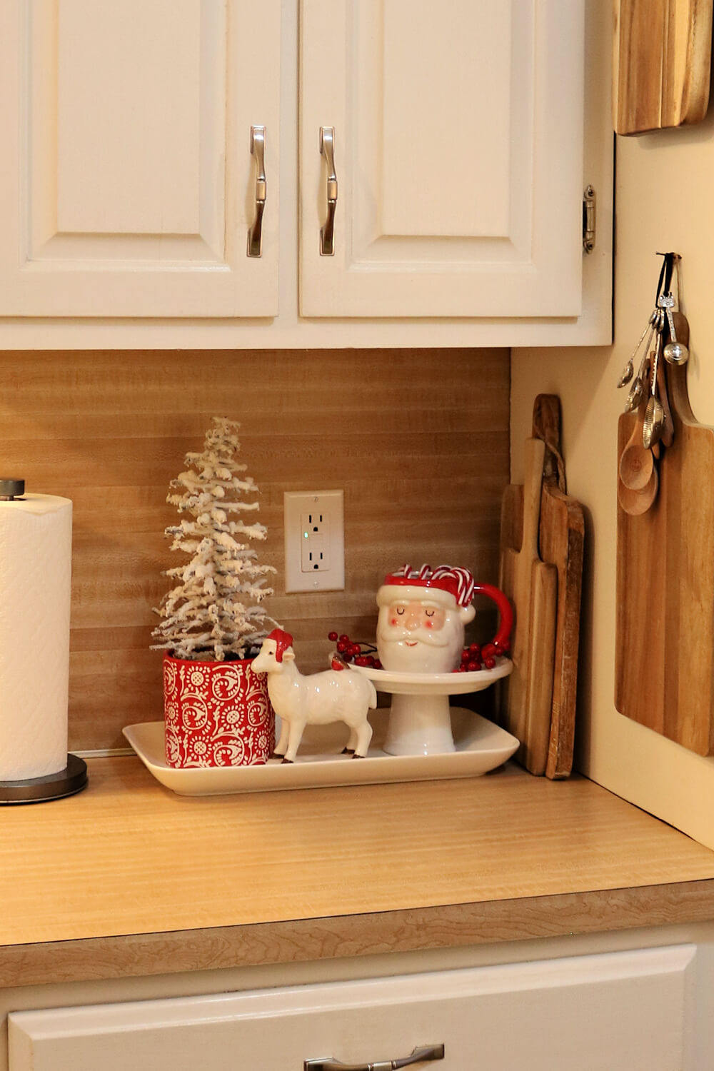 In Christmas Inspiration In The Kitchen, this is my beloved ceramic lamb, a blocked tree and a Santa mug on a stand.