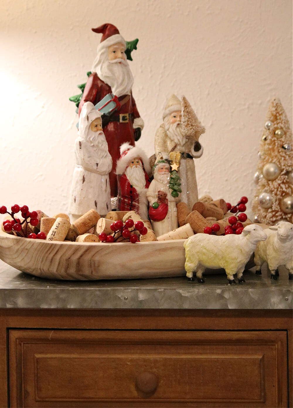 In Dining Room Santa Vignettes, Santas in a dough bowl filled with wine corks