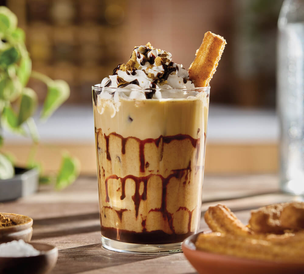 Delicious iced coffee recipes for summer might include this churro con chocolate iced coffee.