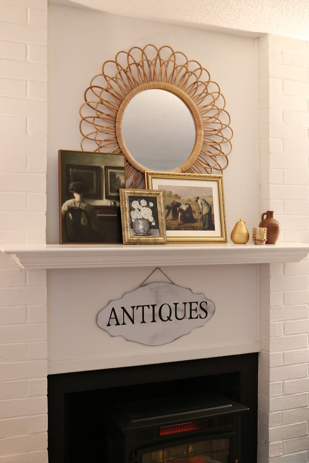My mirror is centered on the wall above the fireplace and the paintings for the January fireplace mantel are below it.