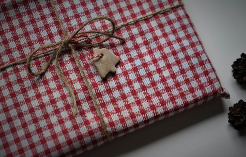 In 8 Unique Eco Friendly Gift Wrapping Ideas, use fabric and jute to wrap presents
