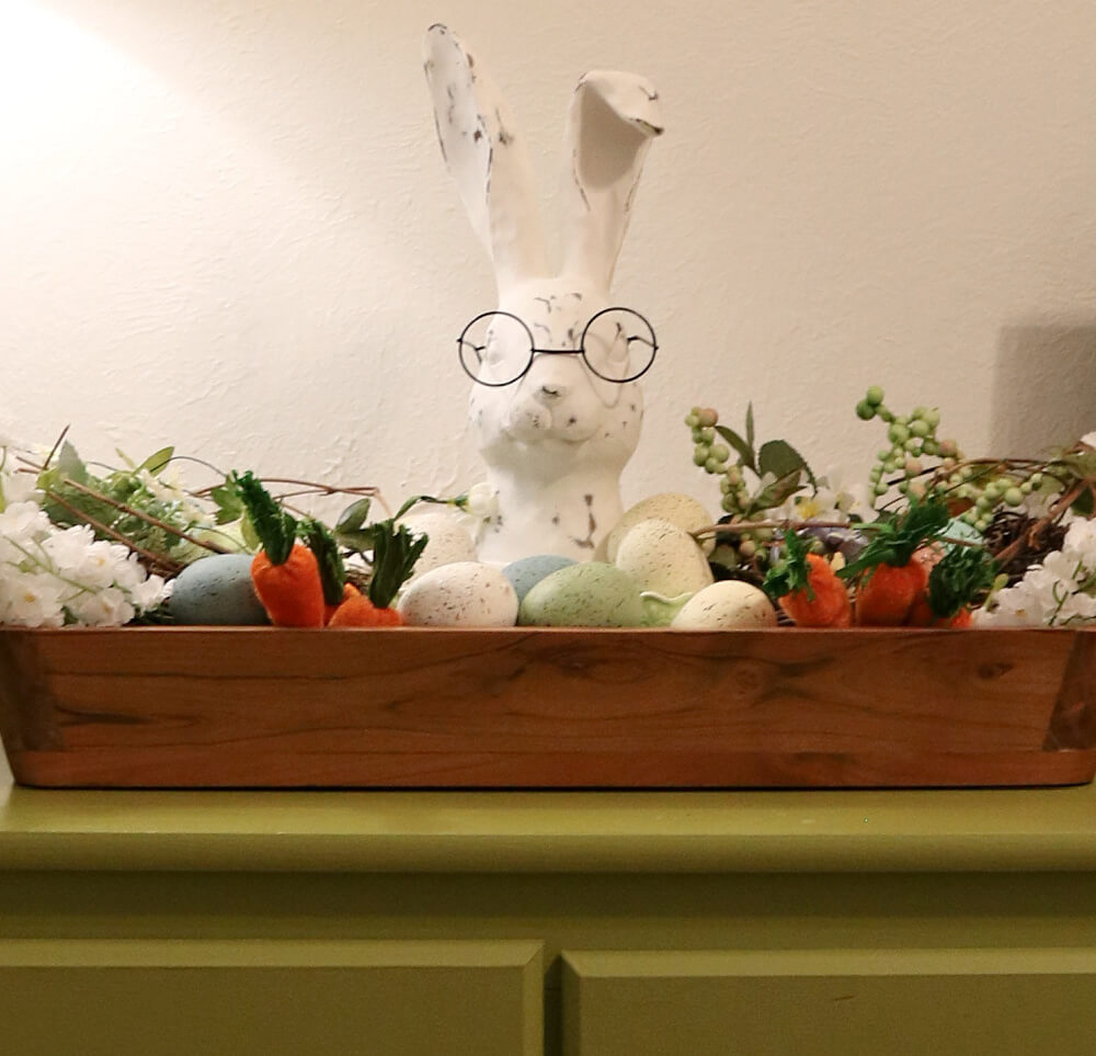 A rabbit with glasses surrounded by Easter decor