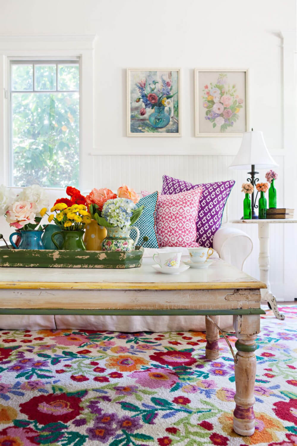 A bright, cheerful living room couch with lots of pretty pillows.