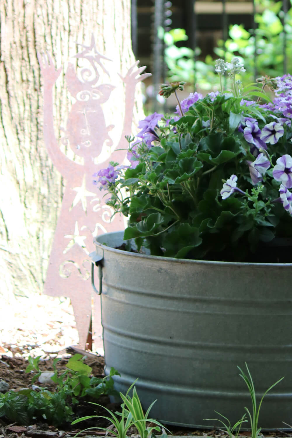 Purple and white petunias in a galvanized container.