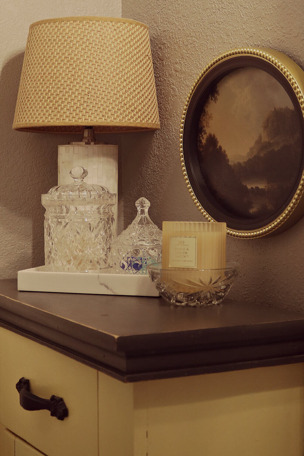 Lighting creates a cozy ambiance in my bathroom with this small lamp on a cupboard in the corner.