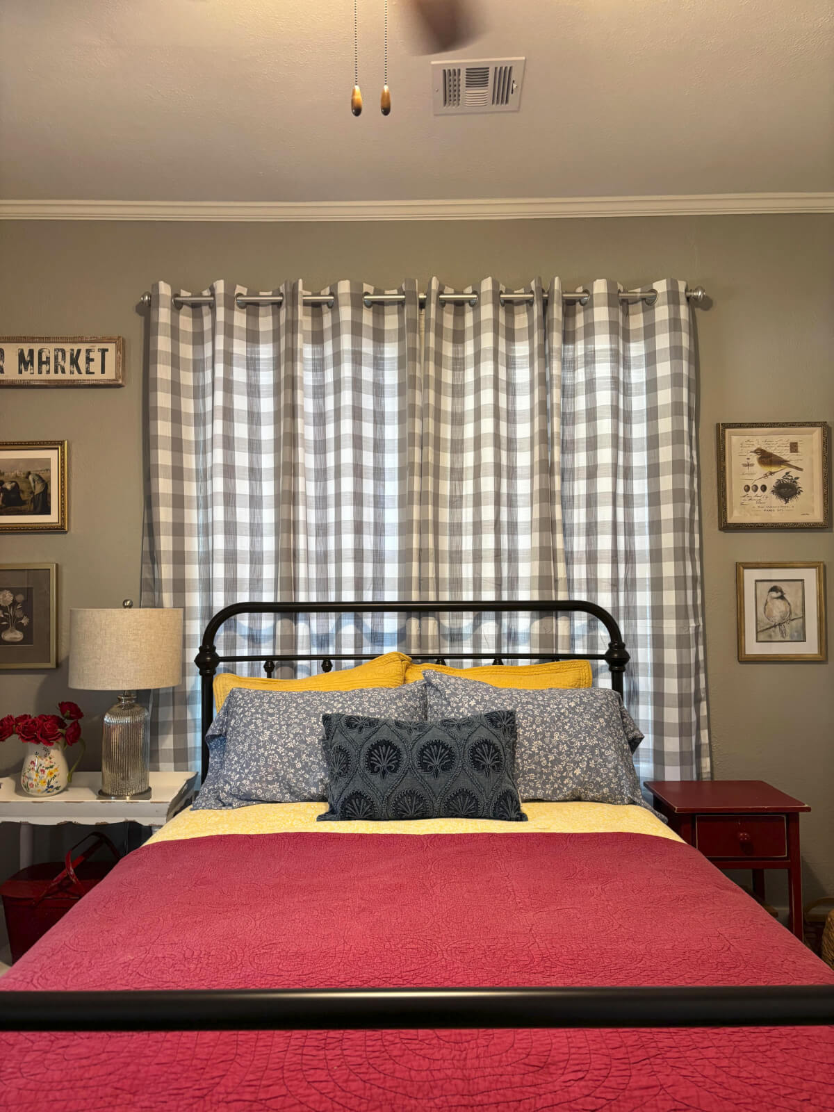 View of the guest room from the door that leads to the hallway. It is decorated in colorful colors and cottage-style decor.