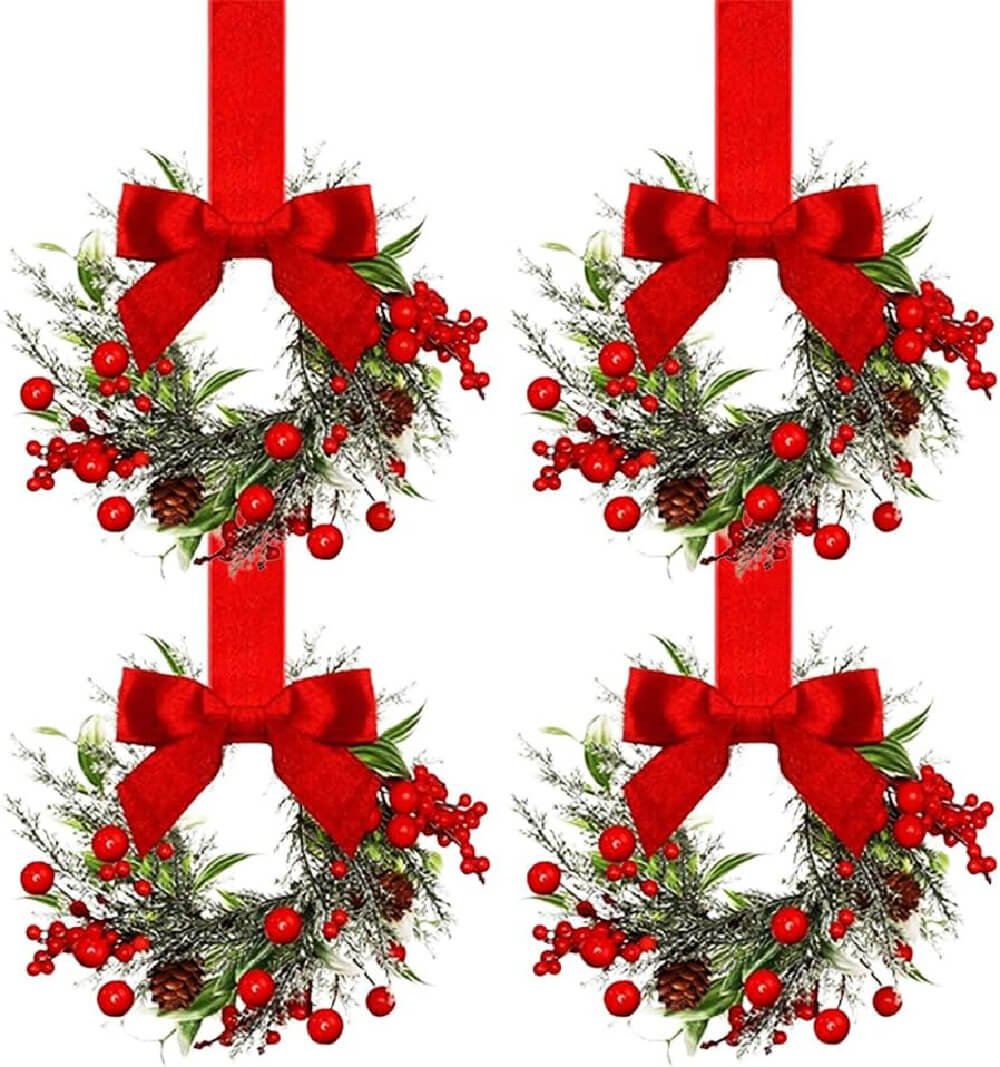 Holiday wreaths for kitchen cabinets with red berries and pine cones and red ribbon.