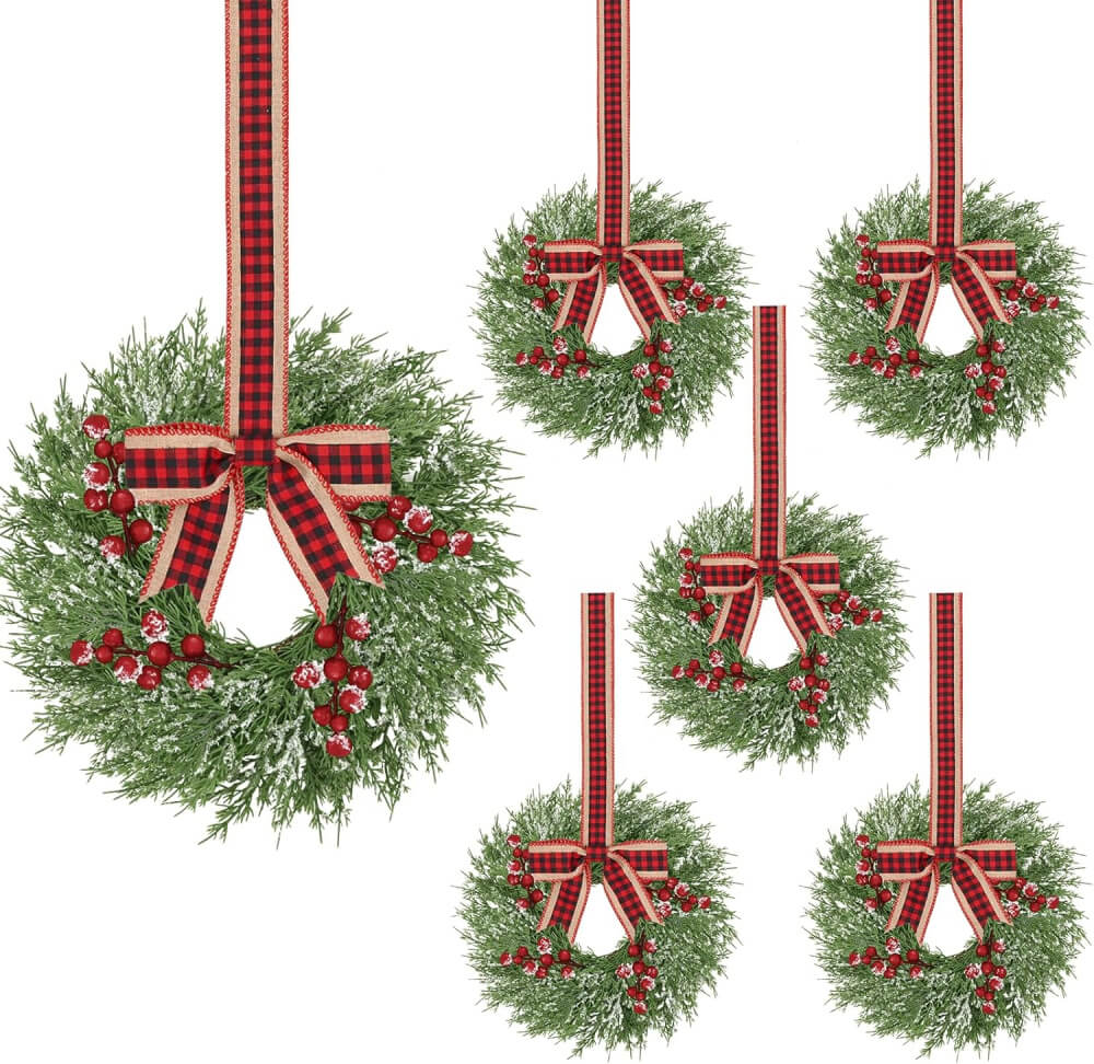 Wreaths with red berries and black and red ribbon.