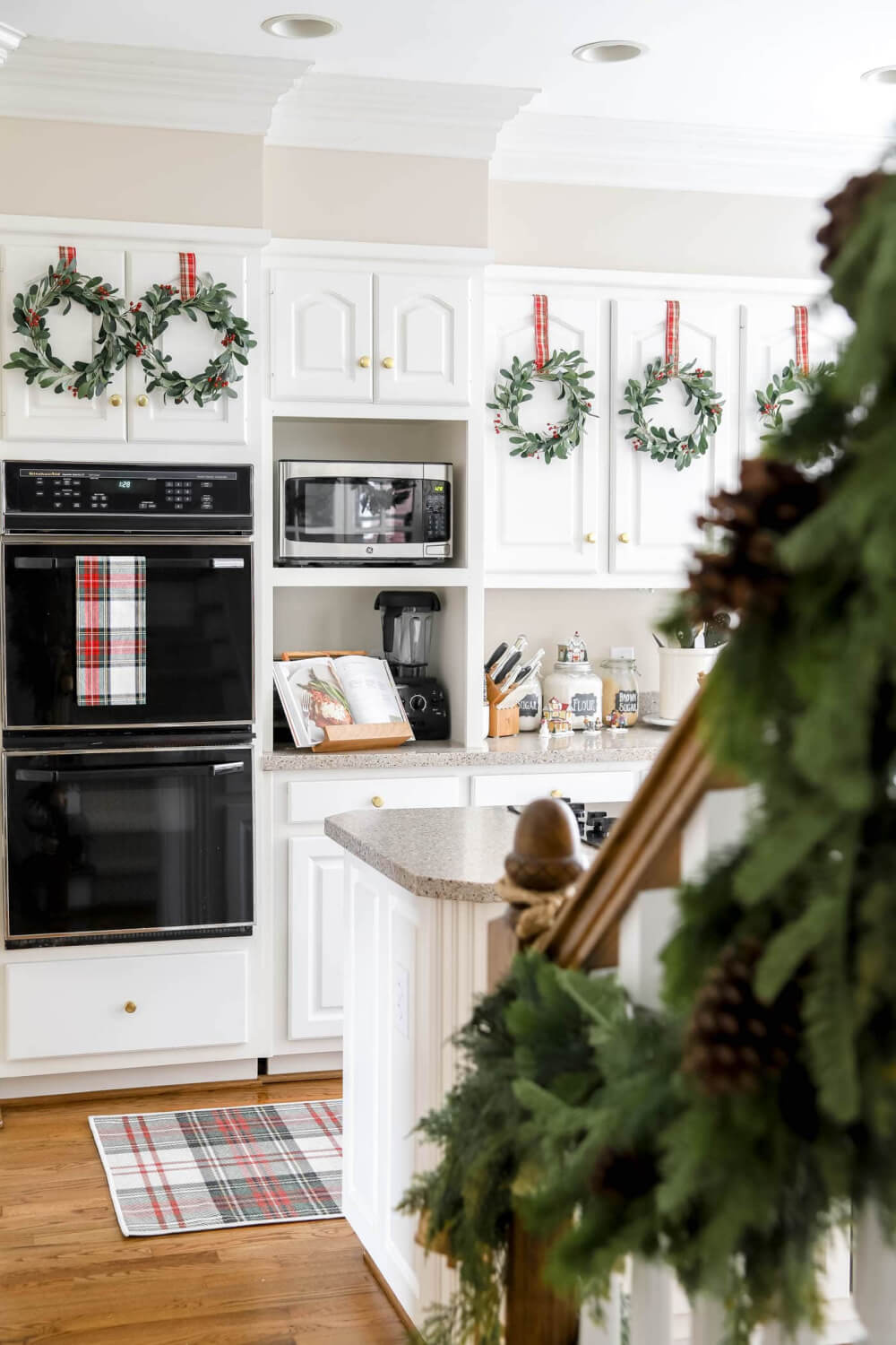 Holiday wreaths and decor for kitchen cabinets with eucalyptus leaves and berries.