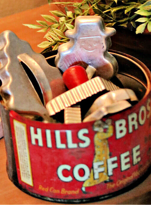 Budget-Friendly DIY holiday decorations is a vintage coffee tin with vintage cookie cutters.