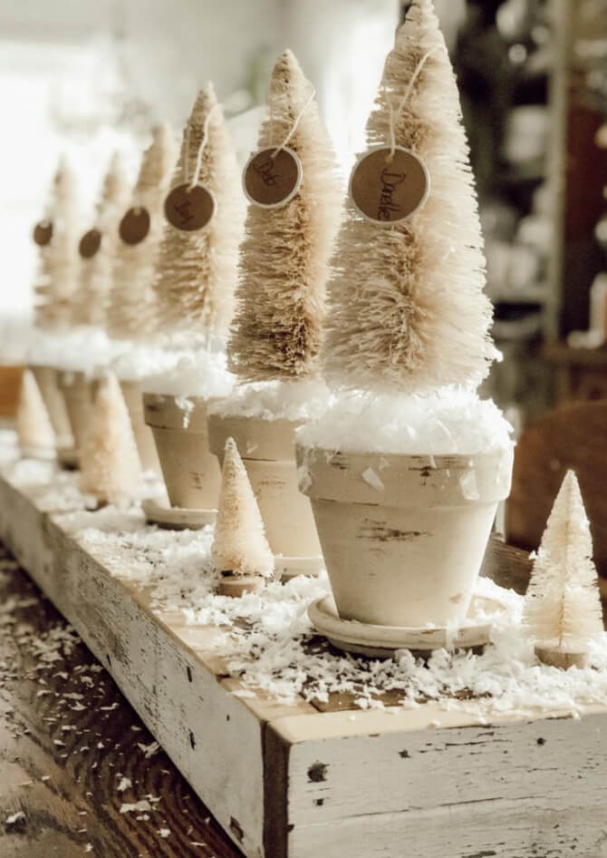 Budget-Friendly DIY holiday decorations with beige painted pots, beige bottle brush trees, and faux snow.