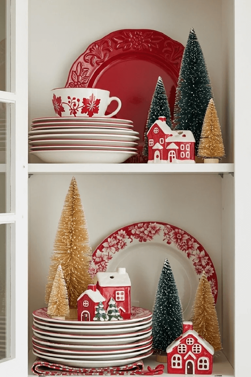 Christmas dinnerware and bottle brush trees inside kitchen cabinets.