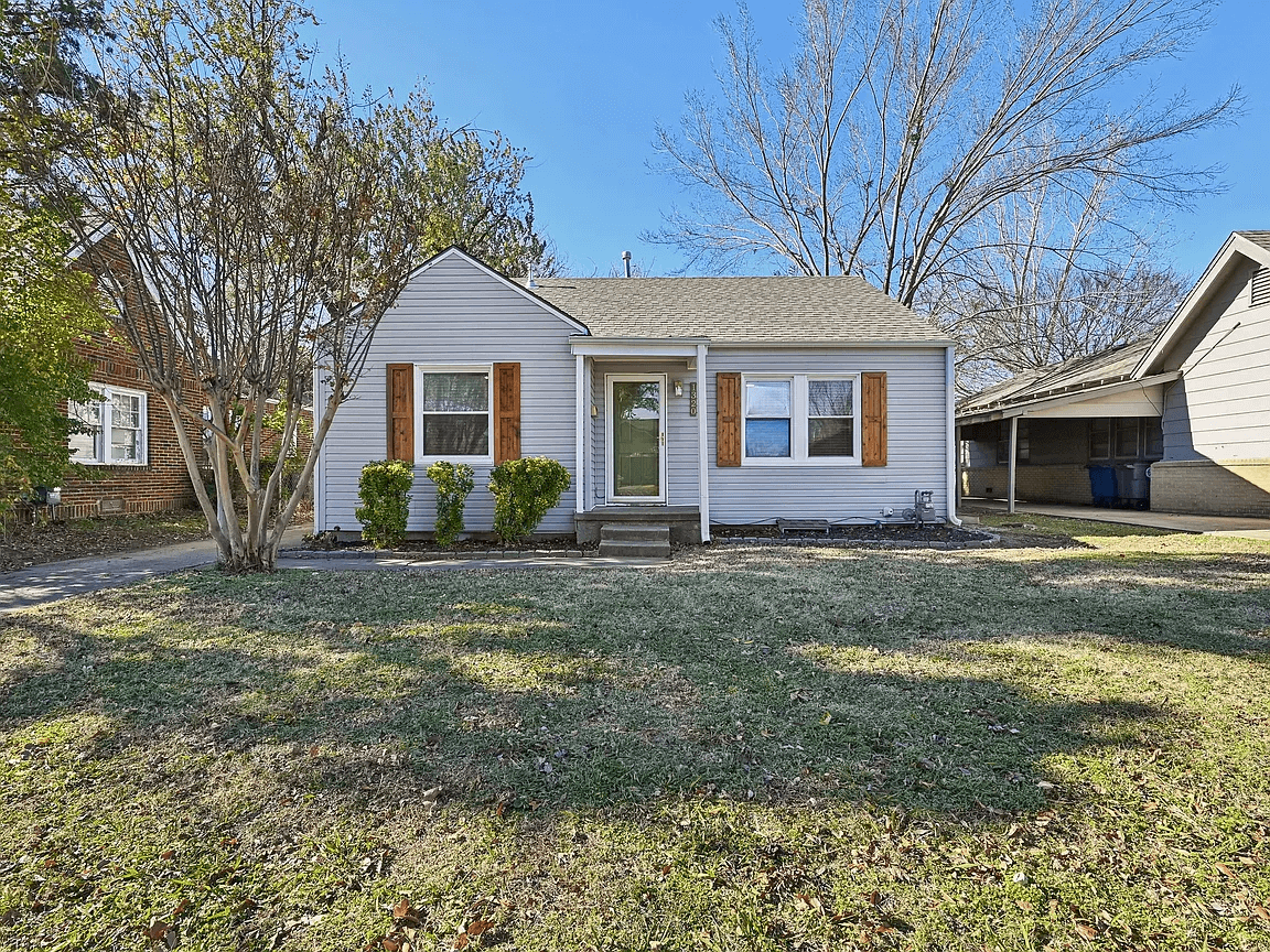 Kendra painted the front door and added beautiful wood window shutters outside.