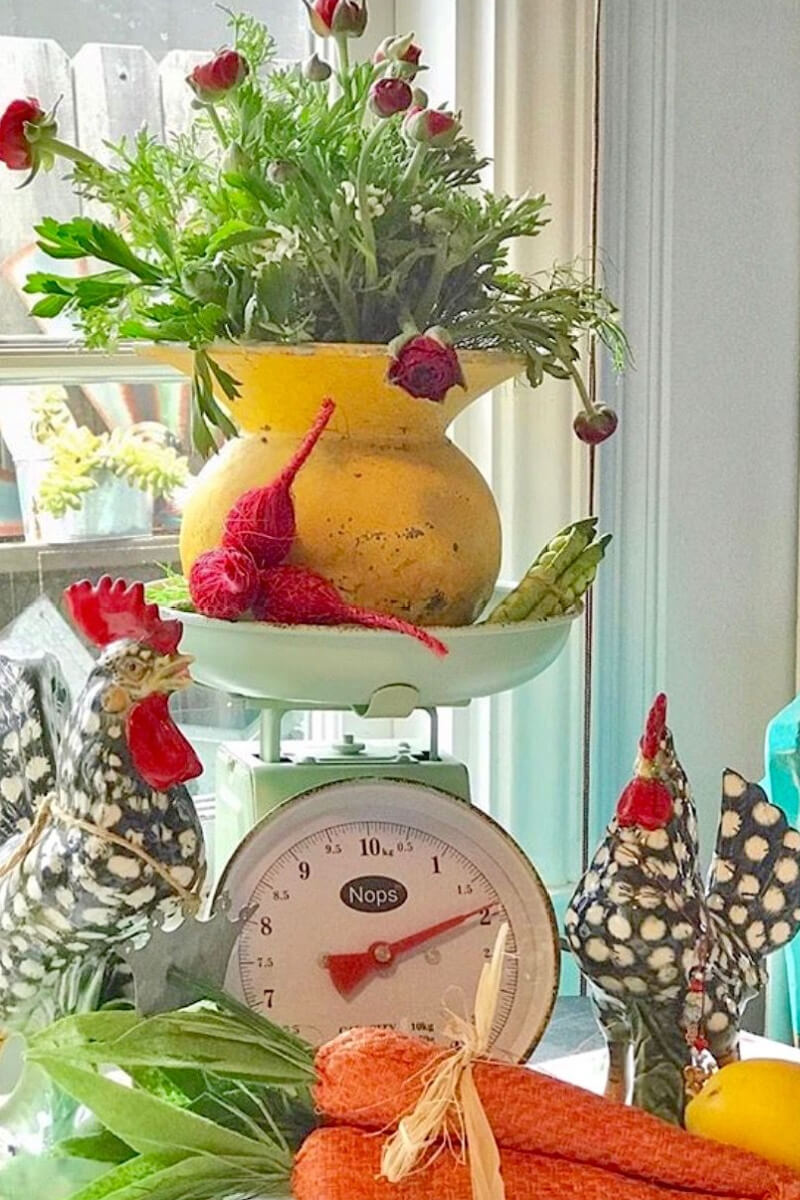 Chickens and roosters are always welcome in a kitschy kitchen. A vintage scale and homemade carrots complete the look.