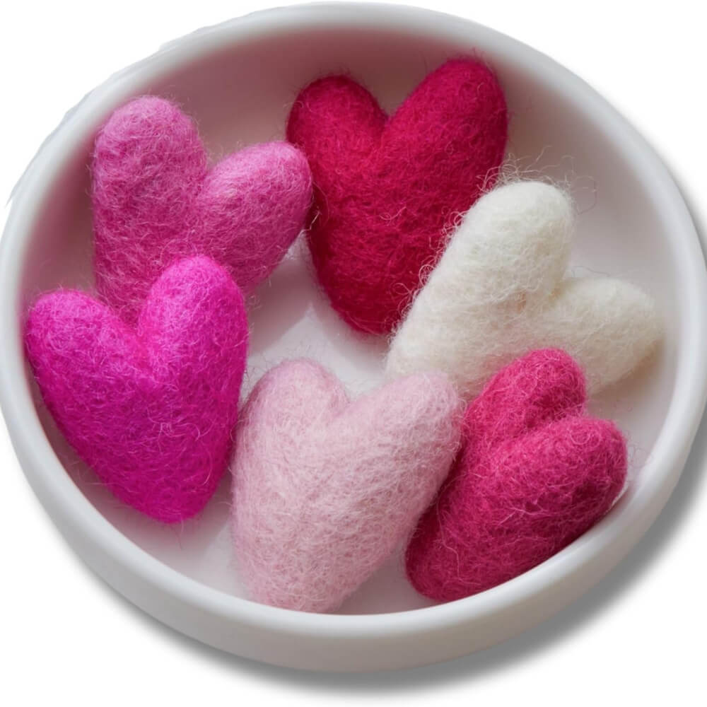Pink and white wool stuffed hearts.