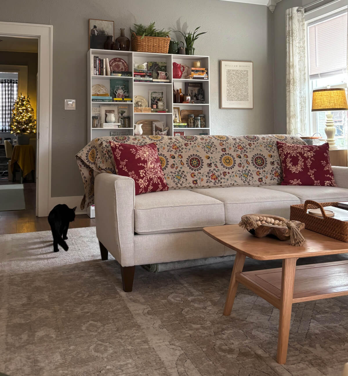 Styling Tips for Bookshelves Behind a Couch means having what you want to see most on the top shelves, as I did.