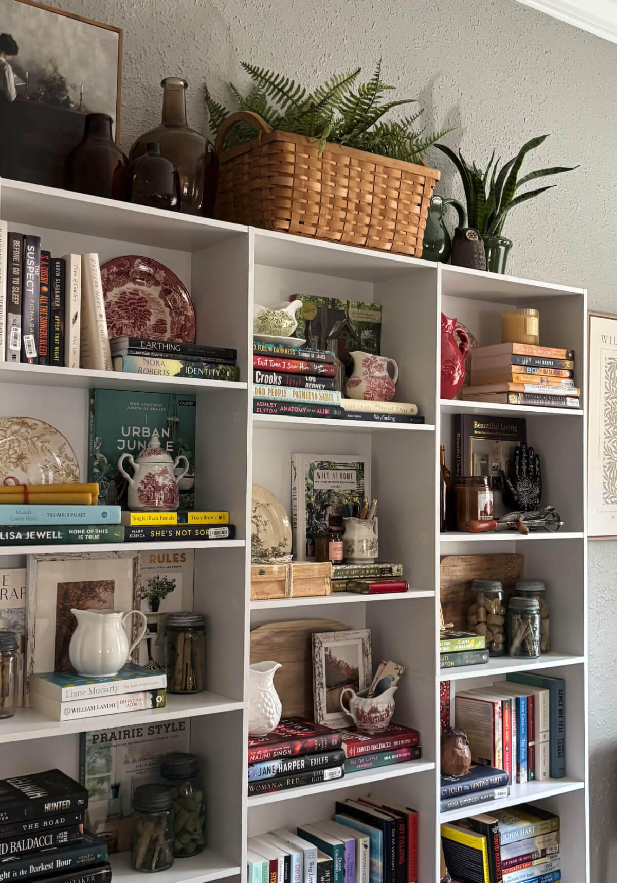 When styling bookshelves behind a couch. mix and match decor.