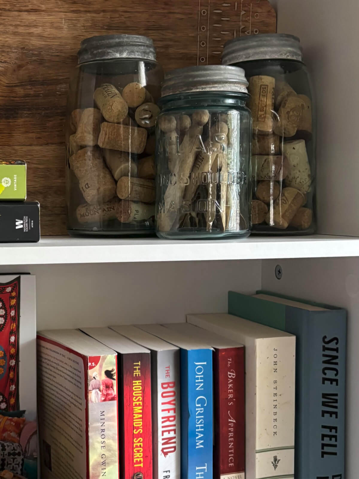 Old vintage jars with wine corks in them as well as vintage clothespins.