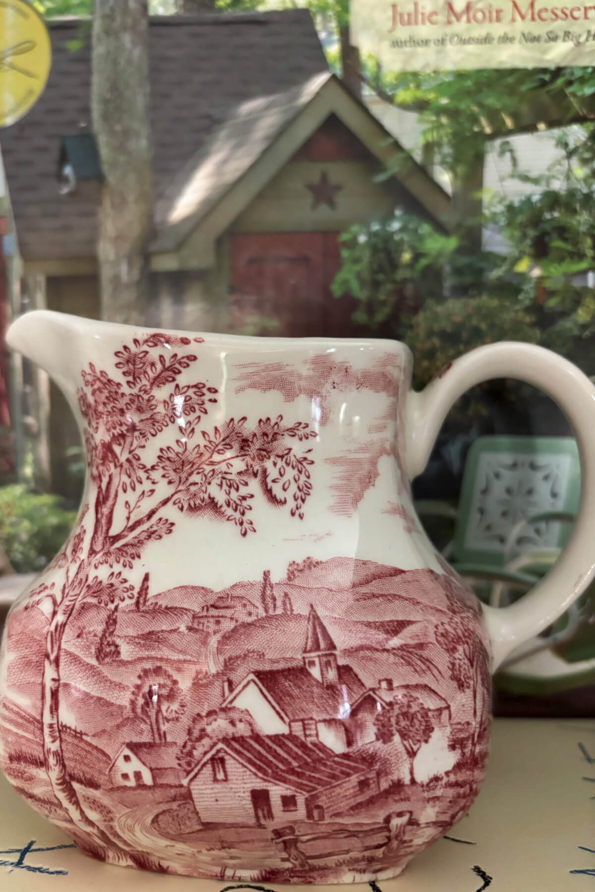 A red and white vintage creamer.