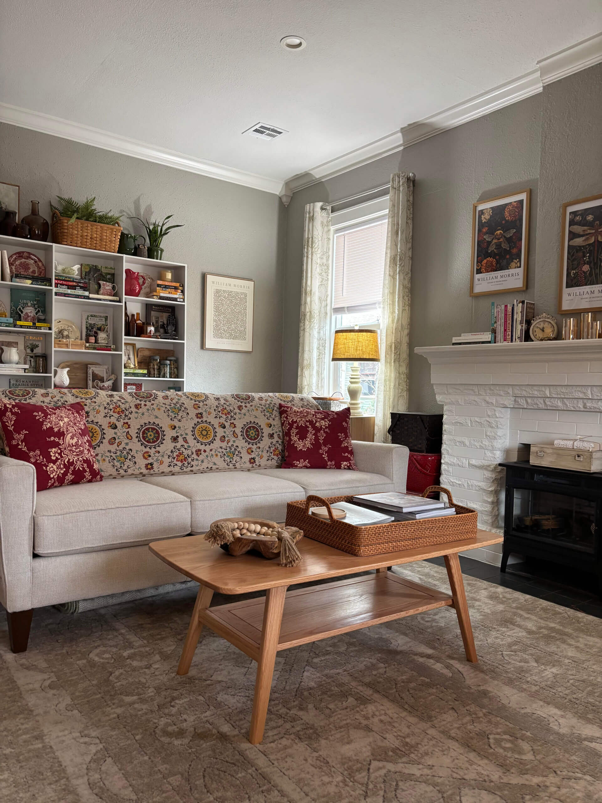 My couch and coffee table near the fireplace, and the shelves behind it.