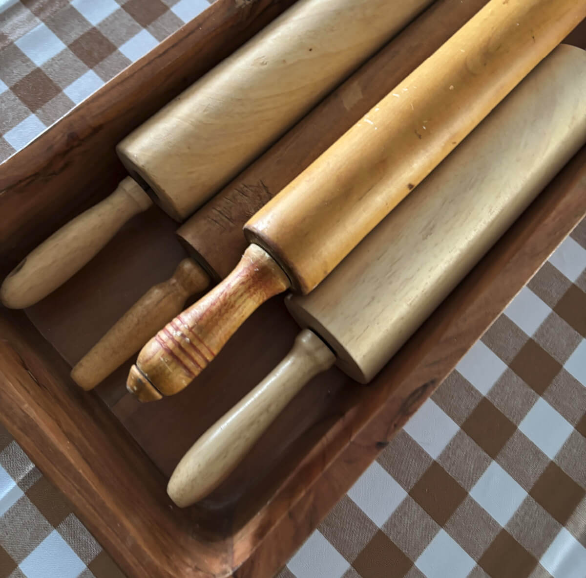 Vintage rolling pins in a wooden bowl on my dining room table.