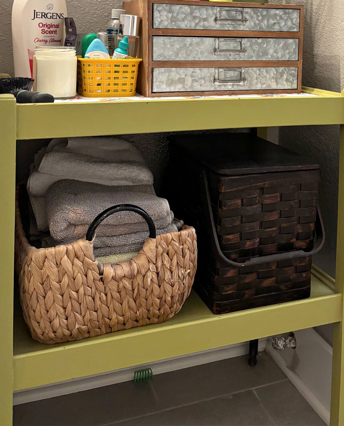 A vintage bar cart in the bathroom is one of my Easy Storage Ideas to Refresh Your Home. Along with baskets for smaller items.