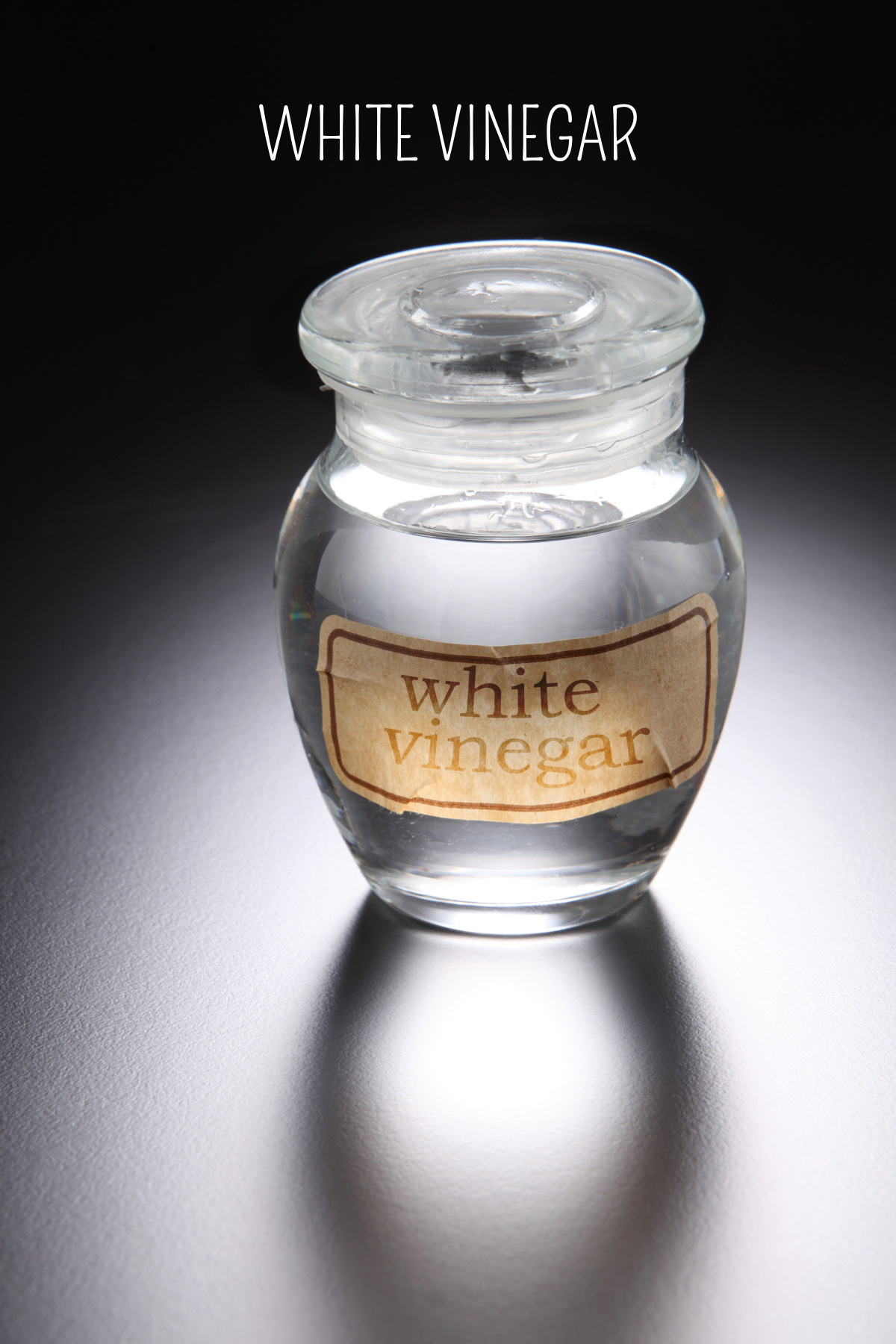 White vinegar in a jar used for cleaning and repelling insects.