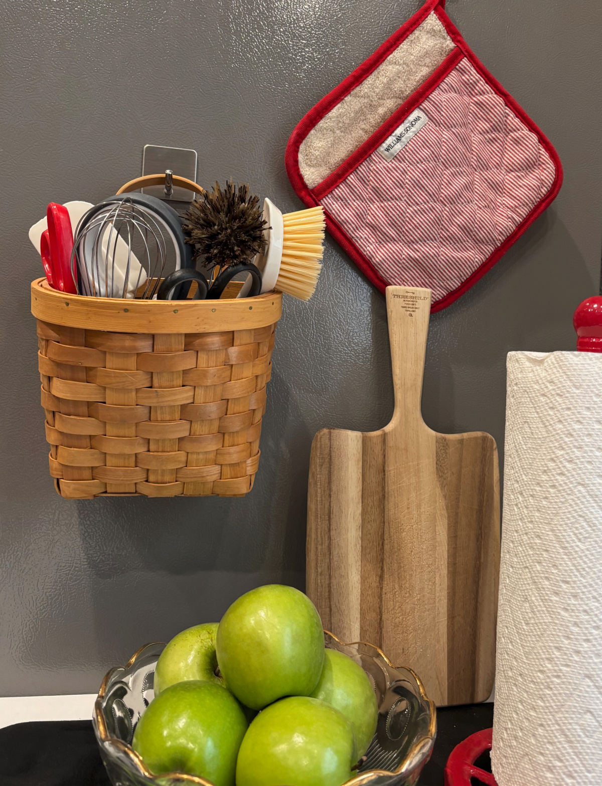 Small changes big impact with this basket storing kitchen stuff hanging vertically.