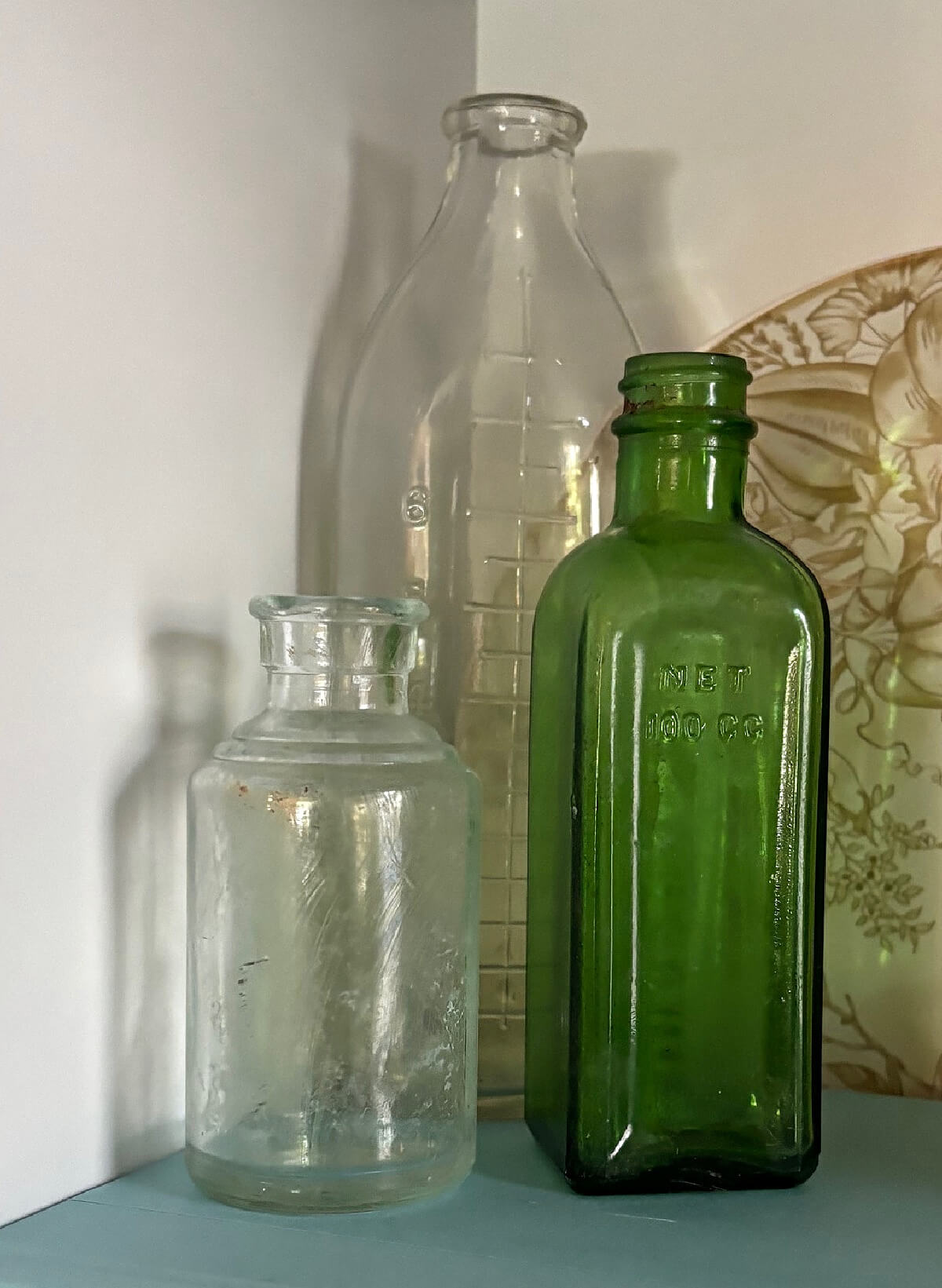 Old clear and green glass bottles.