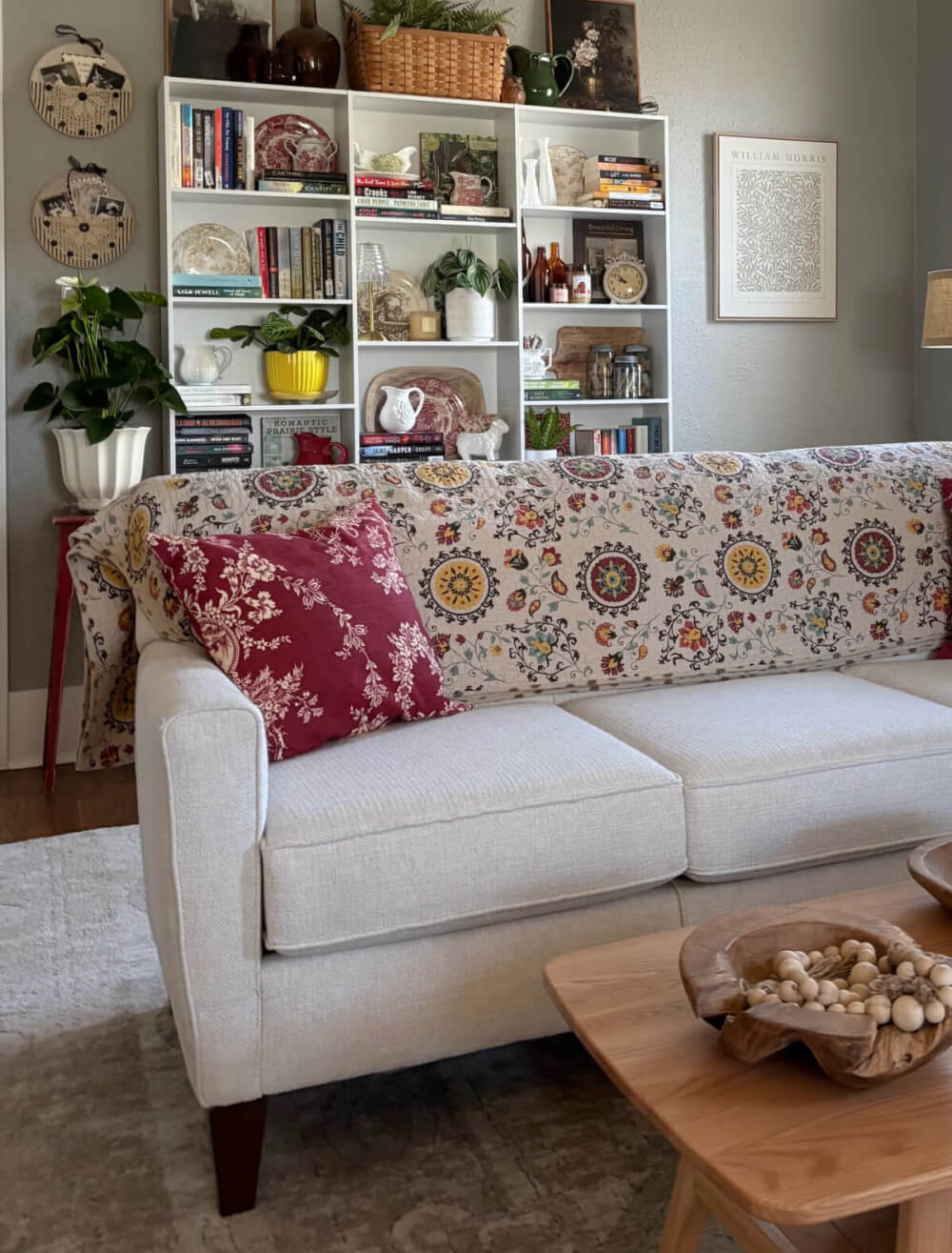 Small changes big impact with the white bookshelves I had added to the wall behind the couch in my living room.