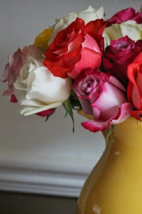 Add a few red roses to a centerpiece.