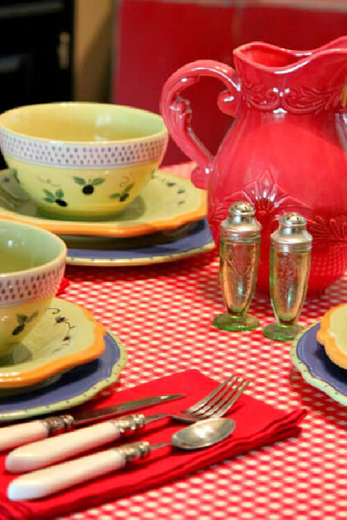 A kitchen table covered with red and white oil cloth.