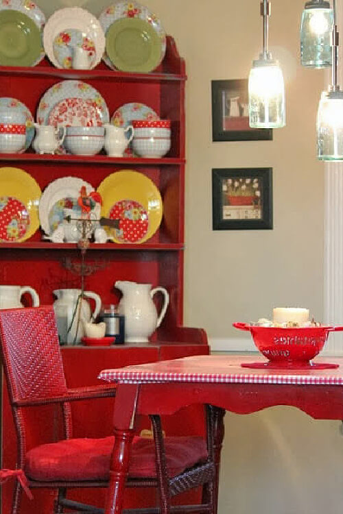 Dishes in the kitchen cupboard before I painted it blue. Red and white oil cloth on the table.