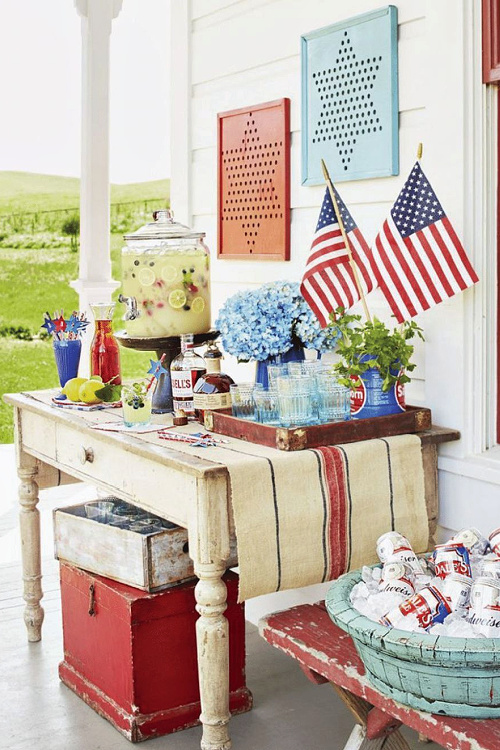 Simple 4th of July porch ideas includes a table for food and beverages.
