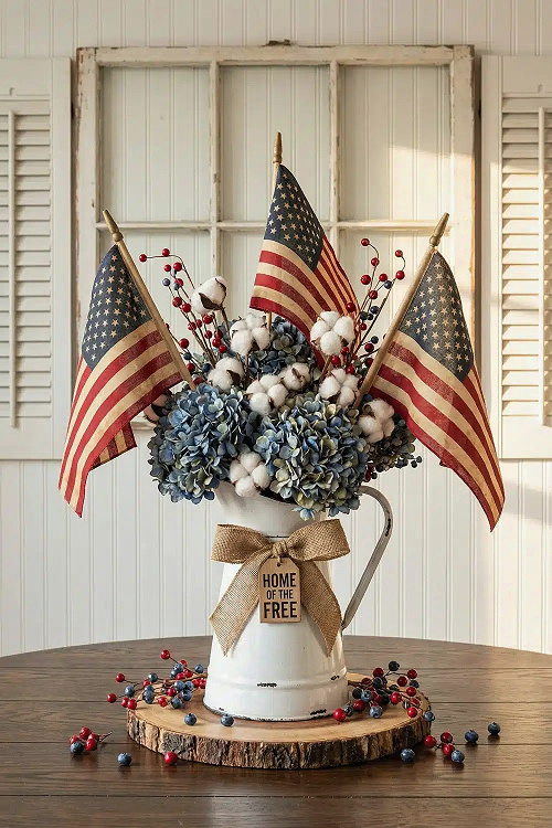 Simple 4th of July porch ideas could be a pitcher with hydrangeas, cotton, and flags.