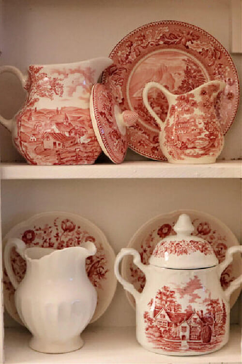 Red and white transfer ware looks lovely in a white cupboard.