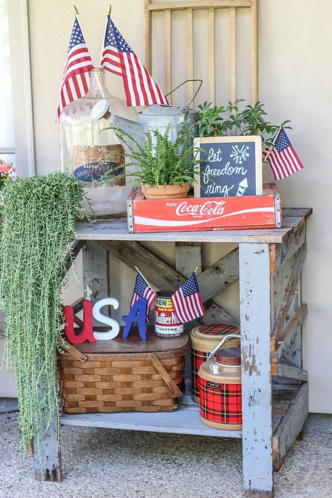 A gray table with a coca-cola crate of related decor.