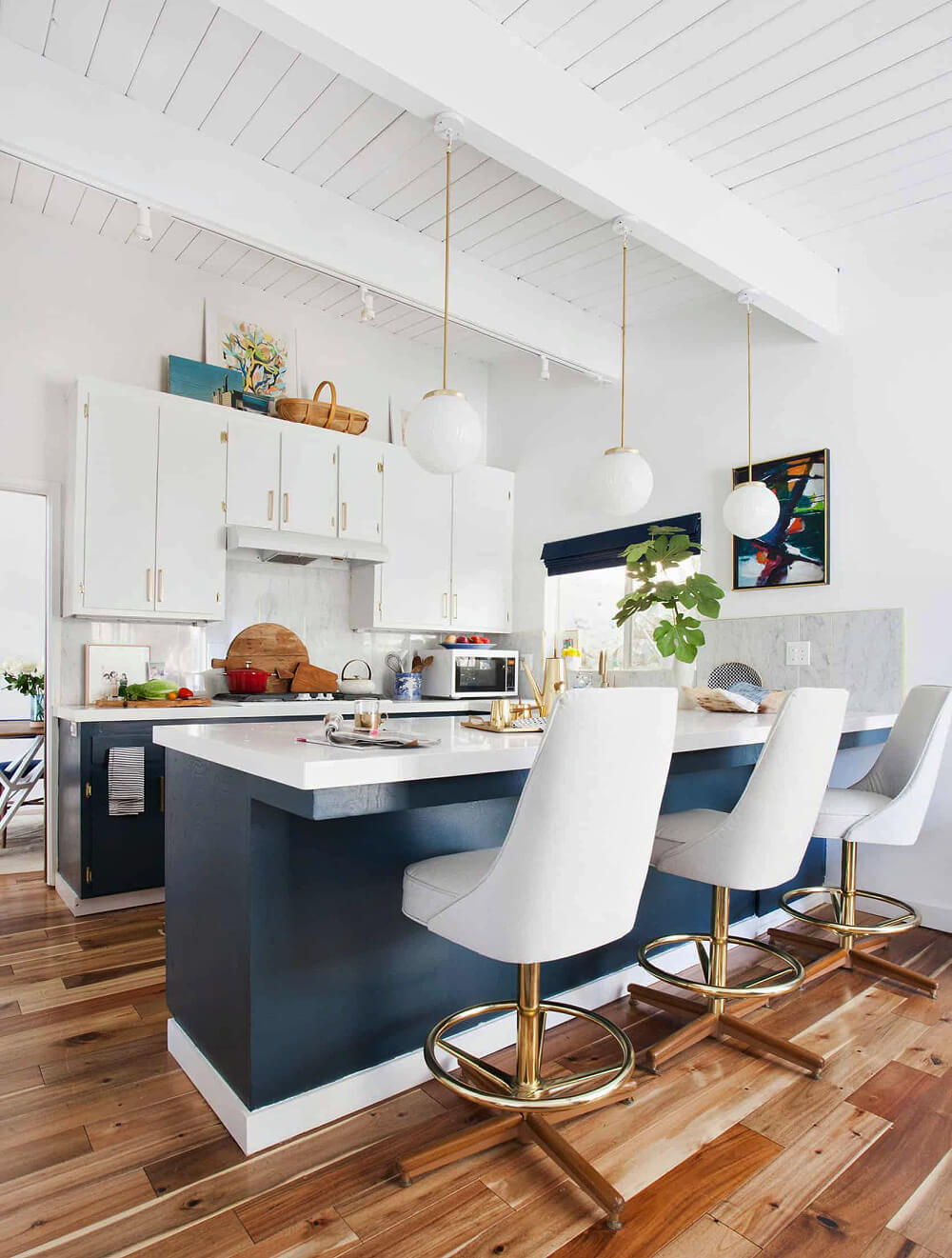In how to style space above kitchen cabinets, this area is decorated with just a few bits of decor.