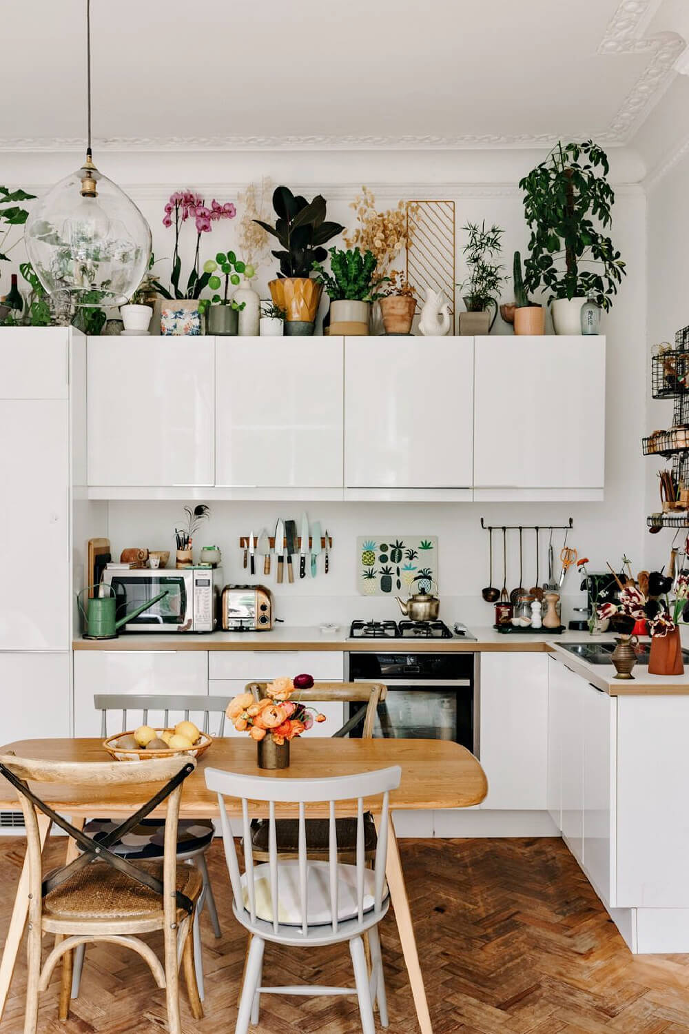 Bohemian decor lined up against the wall, along with house plants.