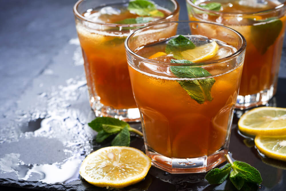 Glasses of iced tea with mint and lemon slices.