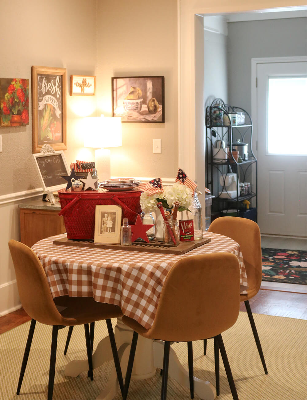 My dining table with brown shutters in the center, and a red, white, and blue vignette on top.
