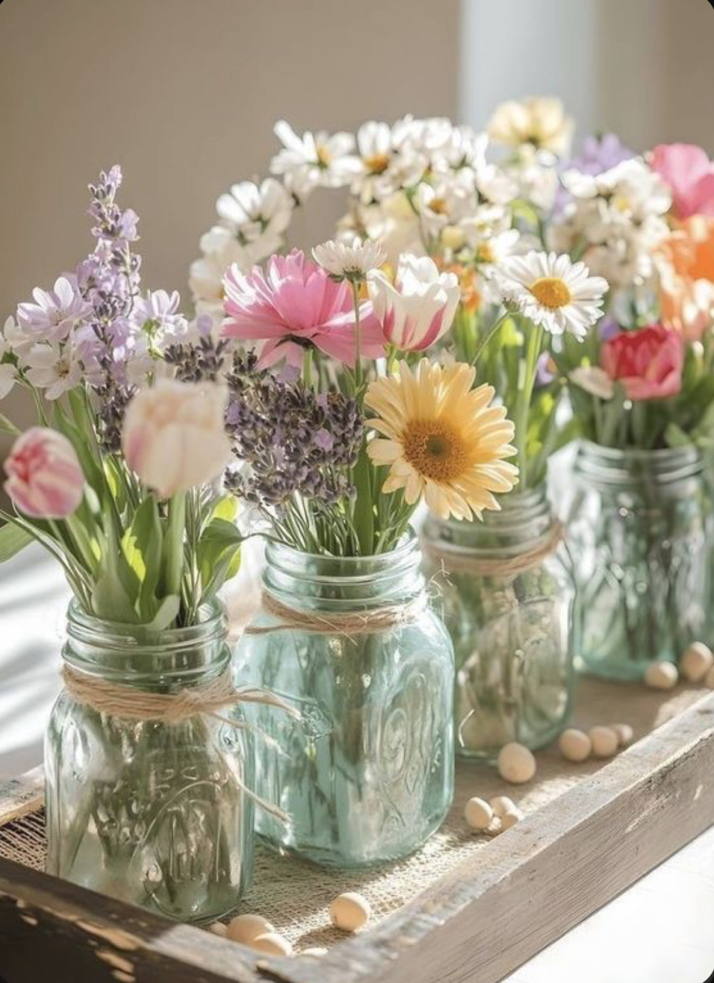 Flowers in a row of jars.