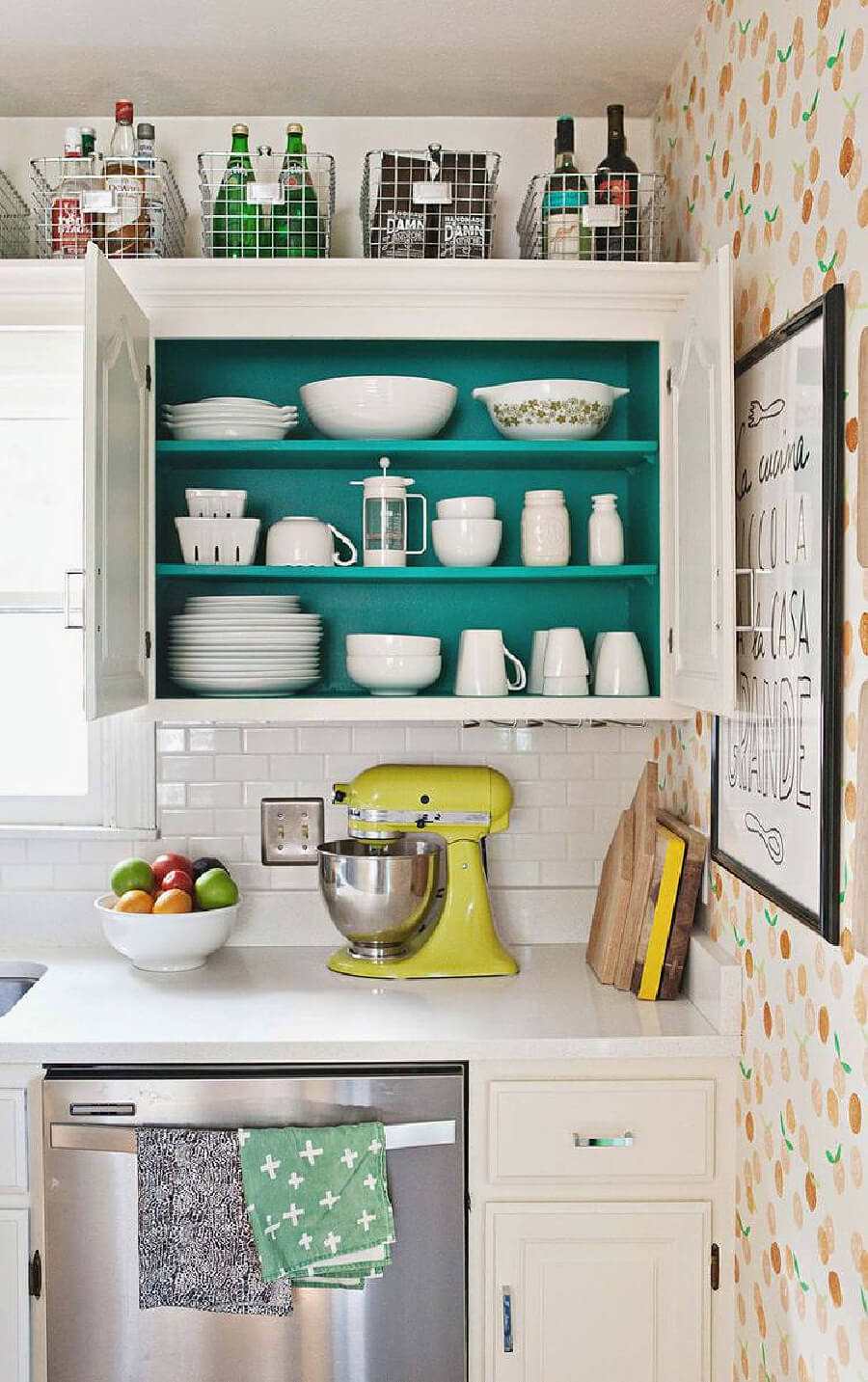 In how to style space above kitchen cabinets, this area is perfect to store beverages for entertaining.