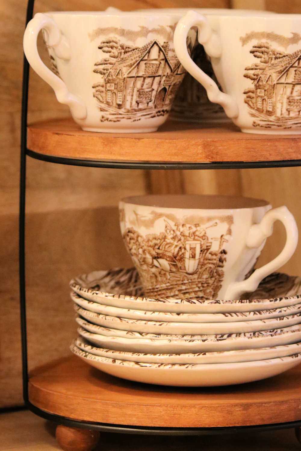 Brown and white transfer ware dessert plates and mugs.