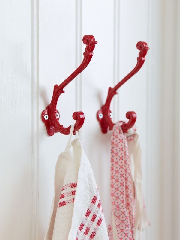 25 Ideas to Organize a Small Kitchen with No Cabinets is to use red hooks on the wall for kitchen towels, etc.