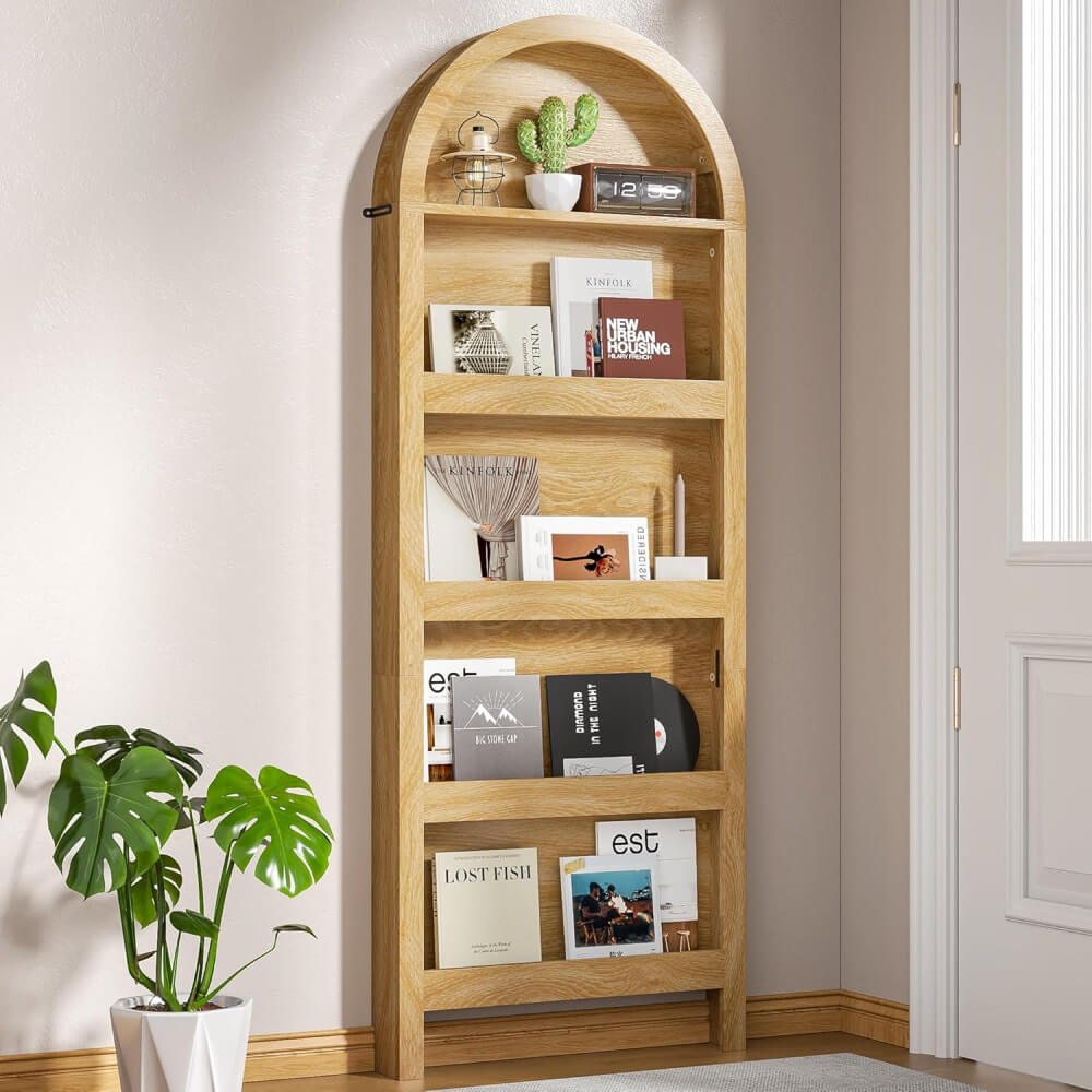 A narrow wood bookshelf with books, etc.
