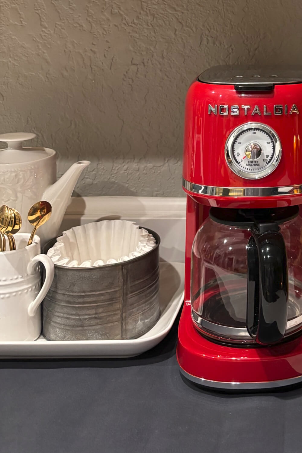My red retro coffee maker alongside things I need to make coffee.