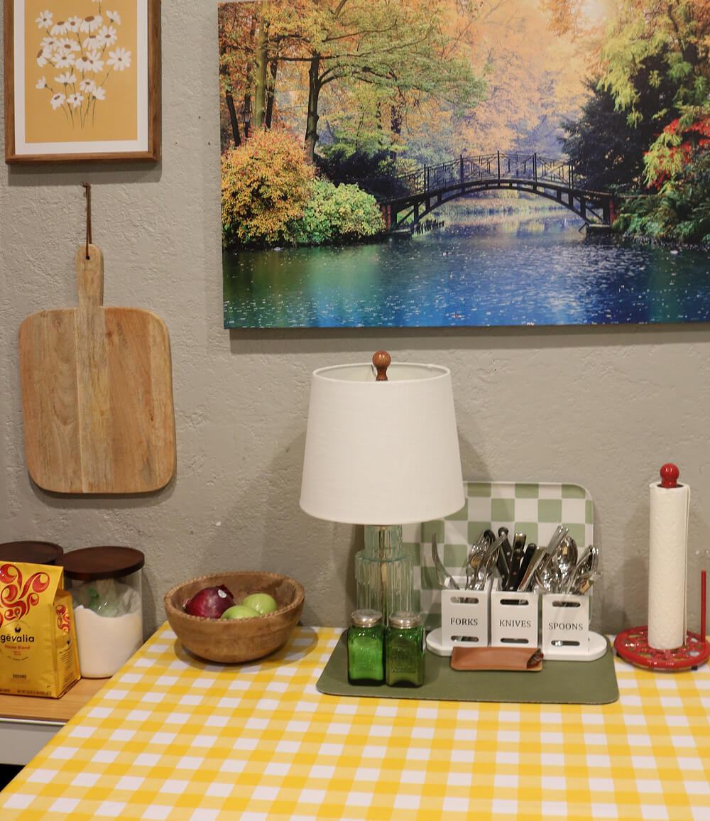 Simple ways to add yellow to your kitchen by switching paintings for one you might have in another room that has shades of yellow in it.