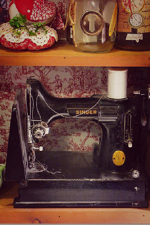 Summing up life in the 1960s, there were Singer Featherweight sewing machines like this black one with white thread. This one is in a small cupboard with a toile backing.