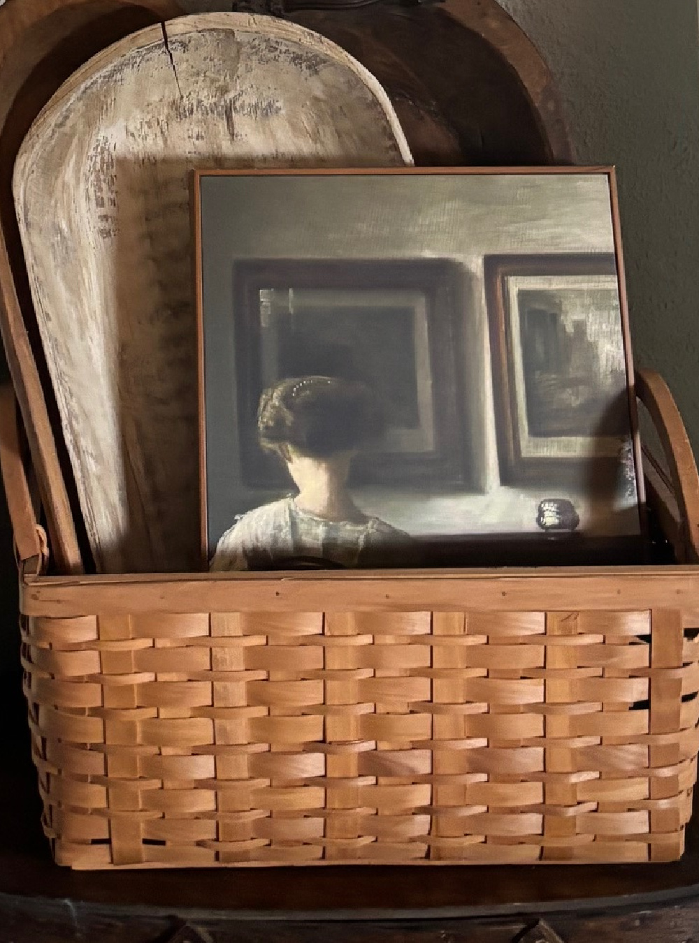 Thrifted basket will dough bowls and a painting inside.